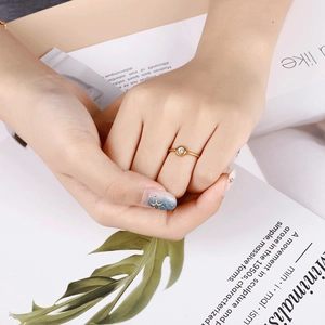 Minimalist rose gold titanium steel ring with single zircon diamond on a finger