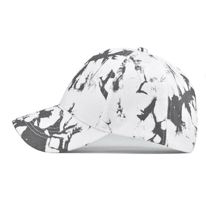 Side view of tie-dye cotton visor cap showing grey ink splash texture and twill fabric
