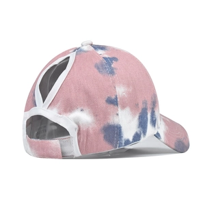 Detail of tie-dye cotton ponytail sun visor with rear triangle opening and velcro strap