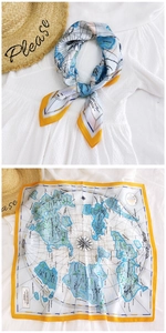 Detail of silk square scarf with yellow border and blue map print pattern