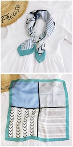 Detail view of geometric silk scarf with blue and green striped patterns for women