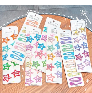 Detail of colorful star and oval metal hair clips set on paper cards for kids