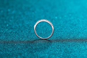 Macro shot of S925 sterling silver half eternity ring featuring sparkling moissanite stones