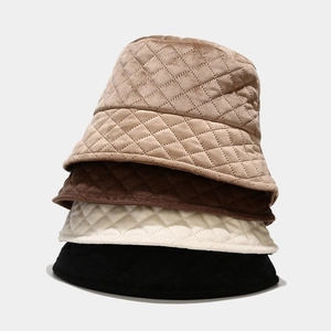 Close-up of quilted bucket hats in four colors showing diamond pattern texture