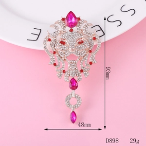 Detail of vintage lion head brooch in rose gold alloy with rhinestones and ruby red stones