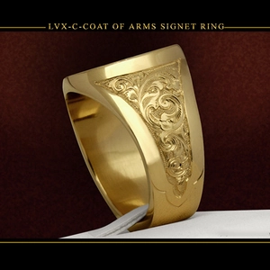 Macro side view of golden signet ring with detailed baroque floral engravings
