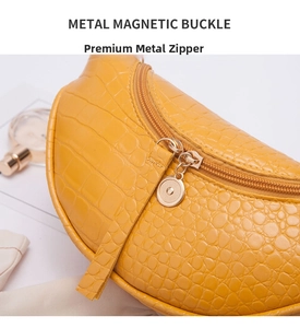 Detail of crocodile texture yellow half-moon bag with golden metal zipper and hardware