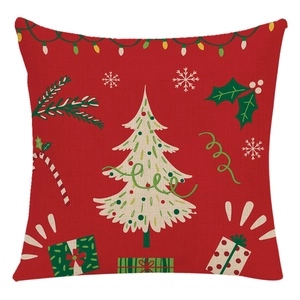 Christmas cushion cover featuring festive red background with tree and gift patterns