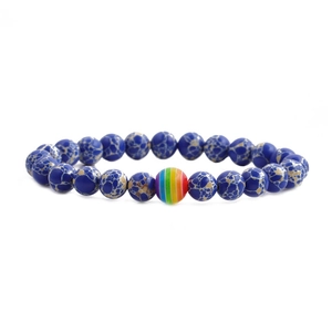 Blue turquoise beaded bracelet with rainbow stripe stone bead on white background