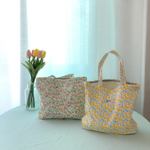Floral and lemon pattern cotton tote bags in pastel colors with dual handles
