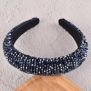 Detailed view of the luxury padded headband featuring dark blue faceted crystal beads