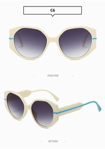 Détail de lunettes de soleil polygonales beige avec branches bleues et verres dégradés violets