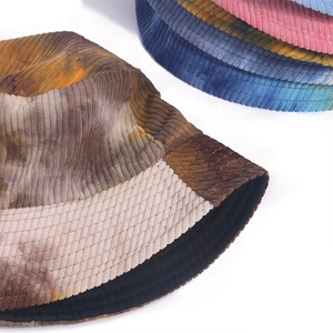 Detailed texture of tie-dye corduroy bucket hat showing various color options
