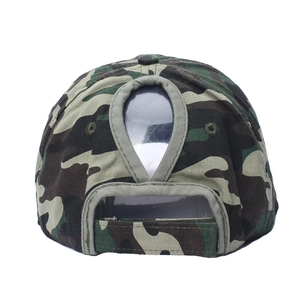 Detail view of cotton ponytail baseball cap featuring woodland camo and velcro closure