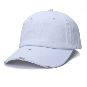 Detail of distressed white cotton ponytail baseball cap with vintage frayed brim effects