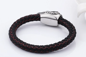 Detail of red and black woven leather bracelet with polished metal magnetic clasp