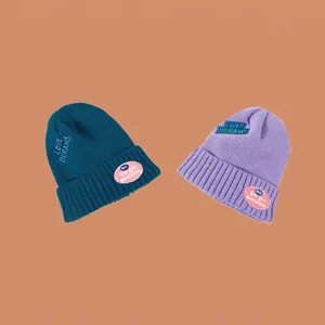 Ribbon knitted beanie with Love Dreams embroidery in dark teal and lilac purple