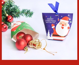 Christmas gift boxes with Merry Christmas greeting ribbon and festive tree decorations