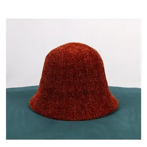 Macro shot of vertical ribbed knit texture on a thick chenille bucket hat for autumn
