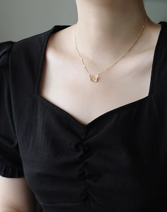Delicate 18K gold butterfly necklace worn on collarbone showing elegant fit and details