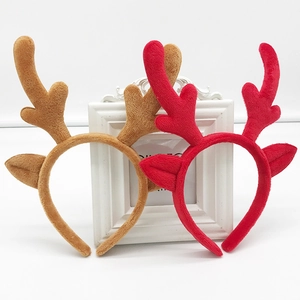 Detail shot of brown and red plush reindeer antler headbands for Christmas parties