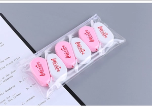 Set of 6 mini pink and white correction tapes in a clear zipper pouch on study desk
