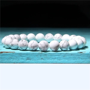 Macro shot of 8mm white howlite stone bead bracelet with natural grey marble textures