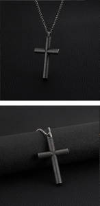 Close-up of black cross pendant with diamond pattern texture on braided chain