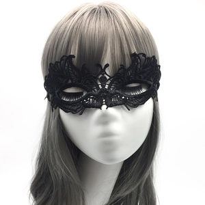 Close-up of black lace masquerade mask with intricate cutout patterns on a female mannequin