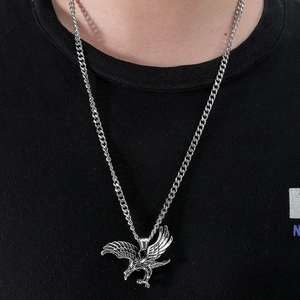 Close-up of vintage soaring eagle pendant on stainless steel Cuban chain for men