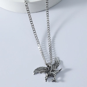 Vintage stainless steel eagle pendant necklace with detailed soaring wings on Cuban chain