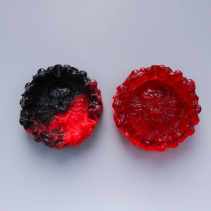 Macro detail of gothic skull resin ashtray molds with red marble and flame edge texture