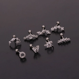 Silver butterfly stud earrings set with zircon stars and moons on a black background