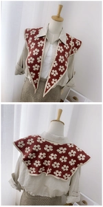 Front and back detail of a knitted red shawl scarf with white flower patterns and beige trim