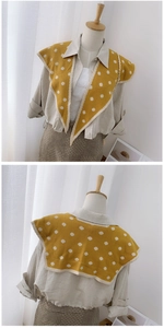 Front and back view of yellow polka dot knit shawl wrap with cream trim on model