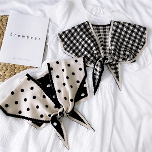 Knitted double-sided shawl with houndstooth and polka dot patterns with bow tie
