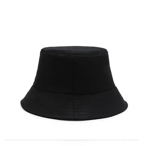 Detail view of the wide brim and clean stitching on a minimalist black cotton bucket hat