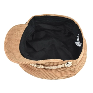 Detail of khaki corduroy baker boy hat showing inner lining and woven rope trim