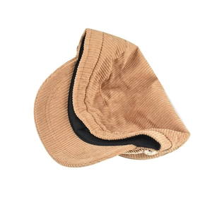 Detail view of khaki corduroy texture and inner sweatband on octagonal baker boy cap