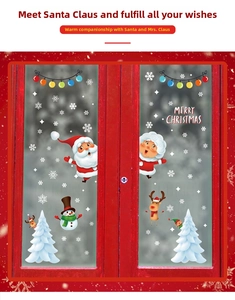 Detail of Santa and Snowman static cling window decals on a red wooden frame