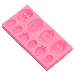 Pink silicone mold featuring detailed skull and skeleton shapes for Halloween DIY baking