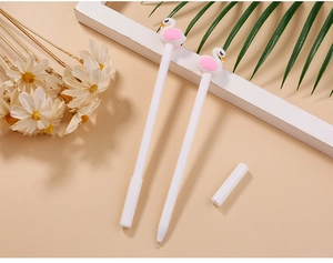 Detail of pink flamingo topper on white gel pen with fine needle tip and floral decor