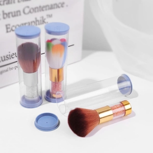 Three colorful nail dust brushes with glitter handles and protective clear cases