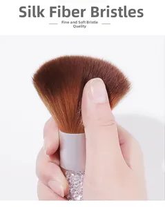 Detail of soft silk fiber bristles on acrylic nail dust brush with diamond handle
