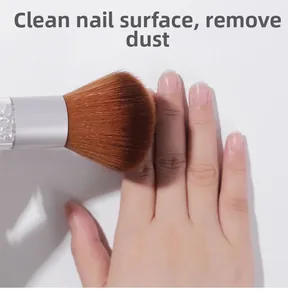 Detail showing nail dust brush cleaning nail surface with soft brown bristles and rhinestones