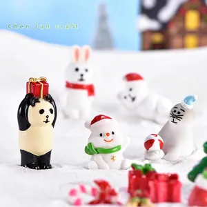 Miniature Christmas figurines set featuring snowman, rabbit, and panda on white snow scene