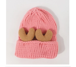 Detailed texture of pink knit baby beanie with cute brown heart-shaped ear 3D decorations