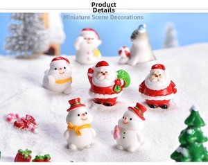 Close-up of Christmas resin figurines featuring Santa and snowmen in a mini snow scene
