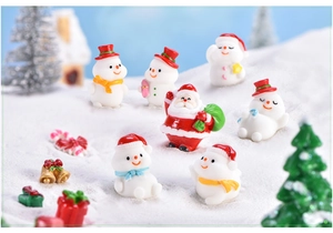 Miniature Christmas set with Santa Claus and cartoon snowmen on a snowy background scene