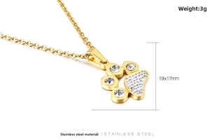 Macro shot of 18K gold plated paw pendant with sparkling rhinestones on stainless steel